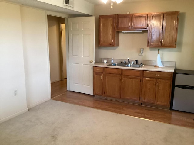 2813 Nile Rd, Chattanooga, TN 37421 - kitchen with light countertops, visible vents, brown cabinets, and a sink