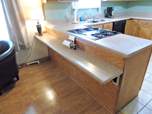 2813 Nile Rd, Chattanooga, TN 37421 - kitchen with a peninsula, light countertops, a sink, dishwasher, and stainless steel gas stovetop