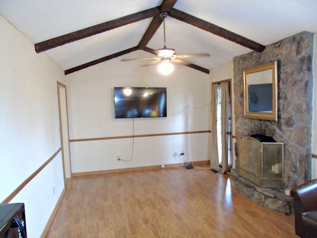 2813 Nile Rd, Chattanooga, TN 37421 - unfurnished living room featuring light wood-style flooring, baseboards, a stone fireplace, ceiling fan, and lofted ceiling with beams