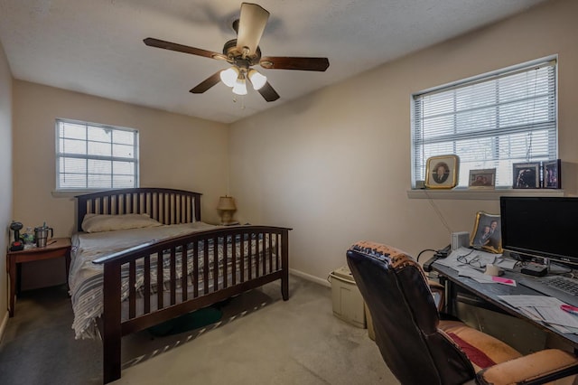 carpeted bedroom with baseboards and a ceiling fan