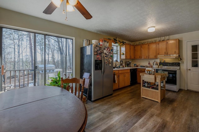 kitchen with stainless steel refrigerator with ice dispenser, under cabinet range hood, range with electric stovetop, black dishwasher, and light countertops