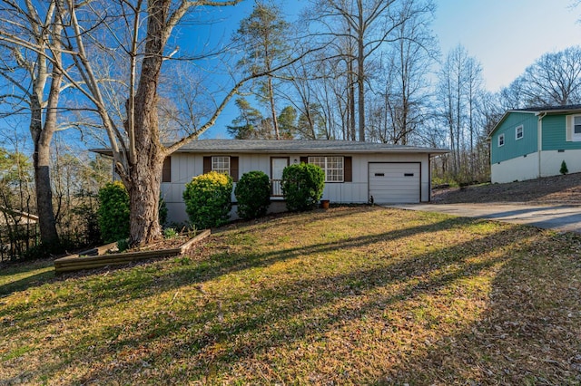 view of front of property with a front yard, a garage, board and batten siding, and driveway