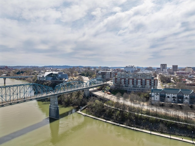 drone / aerial view featuring a city view and a water view