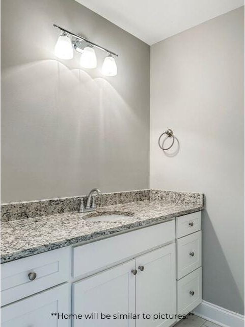 bathroom with vanity and baseboards