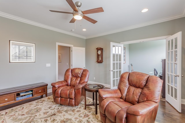 living area featuring baseboards, ornamental molding, french doors, wood finished floors, and a ceiling fan