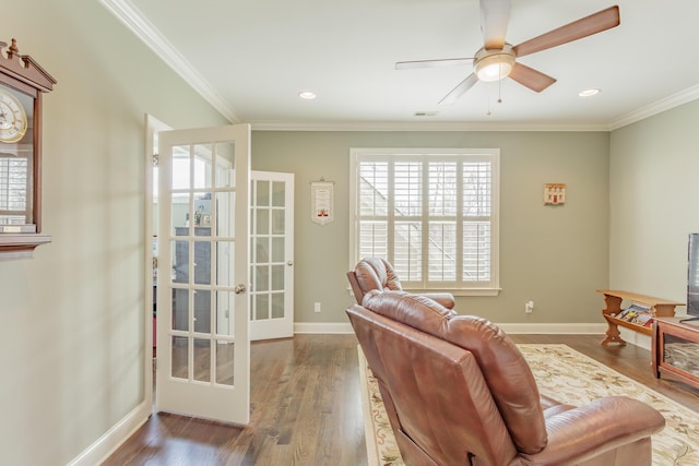 living area with ornamental molding, french doors, and wood finished floors