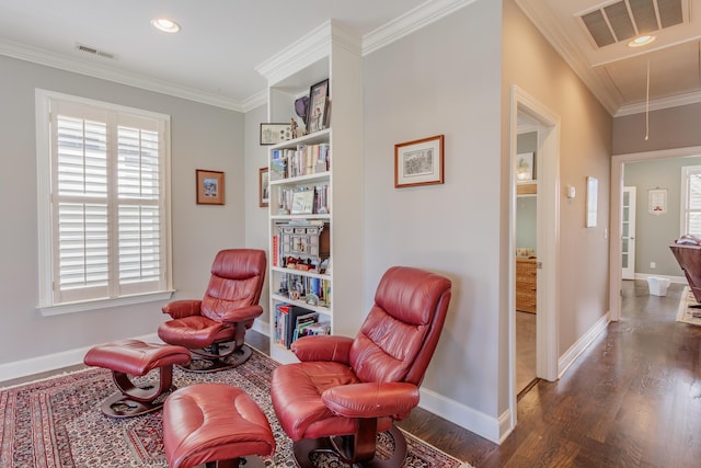 sitting room with visible vents, attic access, and crown molding