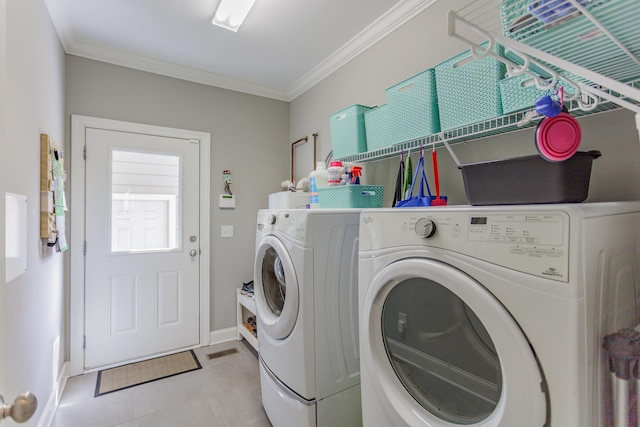 laundry area with laundry area, crown molding, separate washer and dryer, and baseboards