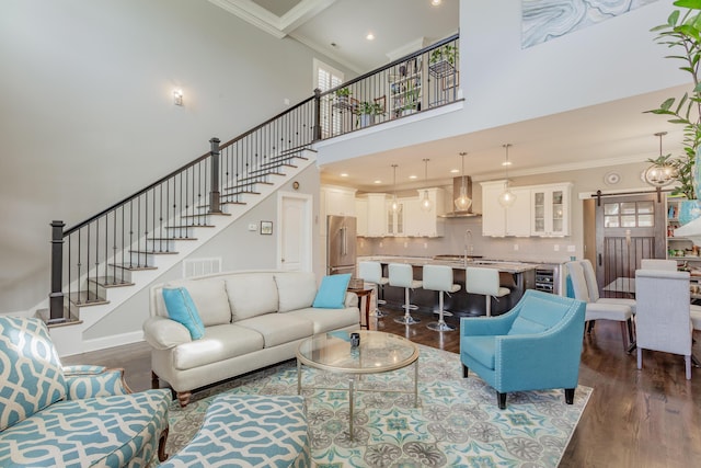 living area with visible vents, crown molding, wine cooler, stairway, and dark wood-style floors