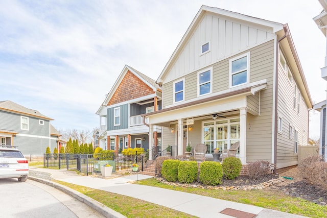 view of front facade featuring a ceiling fan, fence, a porch, a residential view, and board and batten siding