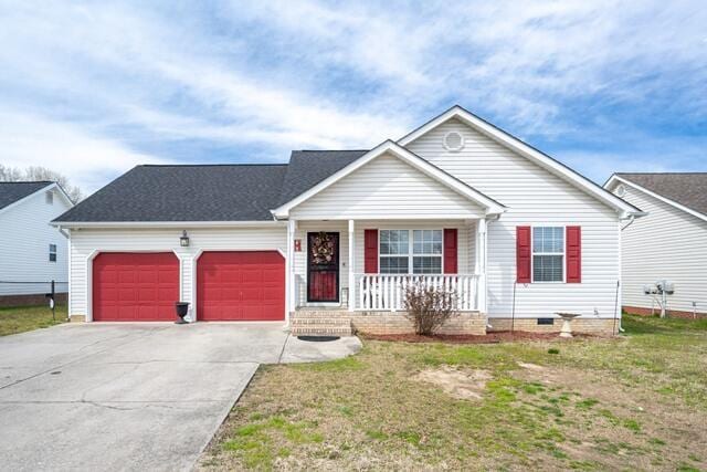 ranch-style home featuring a front lawn, an attached garage, covered porch, and driveway