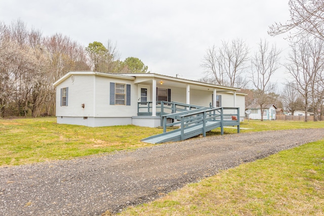 manufactured / mobile home with crawl space, covered porch, driveway, and a front yard