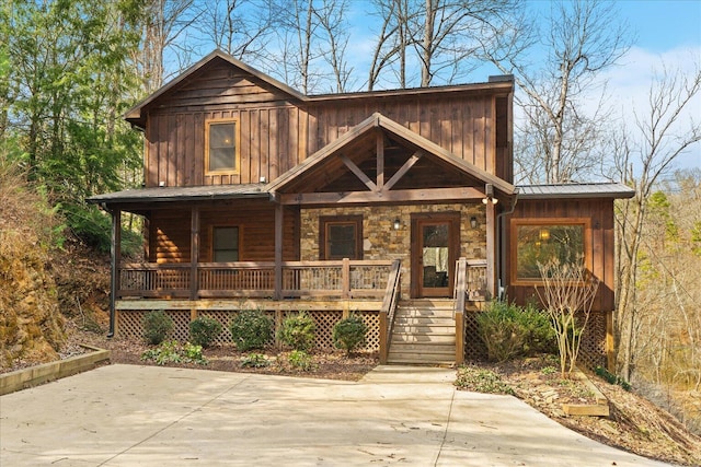 view of front of house with a porch, board and batten siding, and metal roof