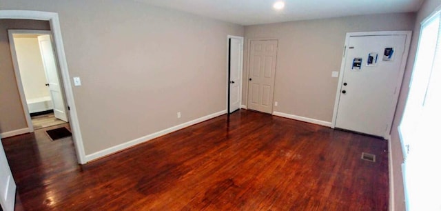 interior space featuring visible vents, baseboards, and wood finished floors