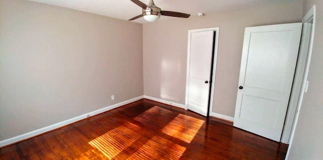 unfurnished bedroom featuring a closet, ceiling fan, baseboards, and wood finished floors