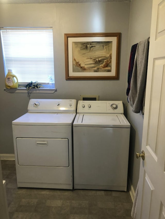 laundry room with baseboards, laundry area, and washer and clothes dryer