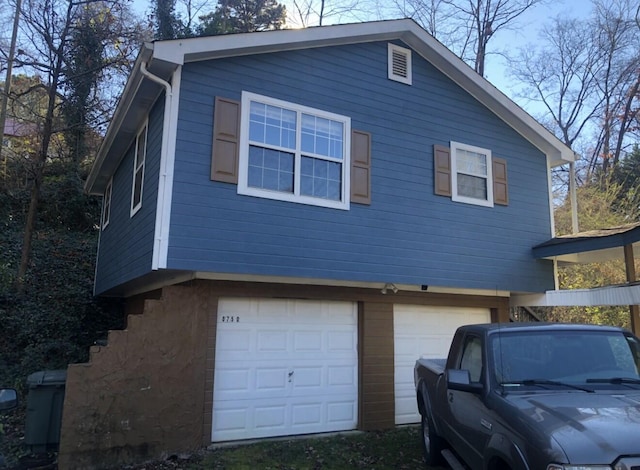 view of side of property featuring a garage