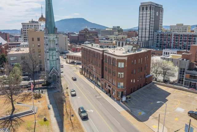 property's view of city featuring a mountain view