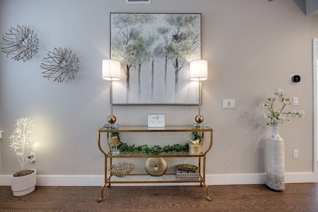 interior details featuring wood finished floors and baseboards