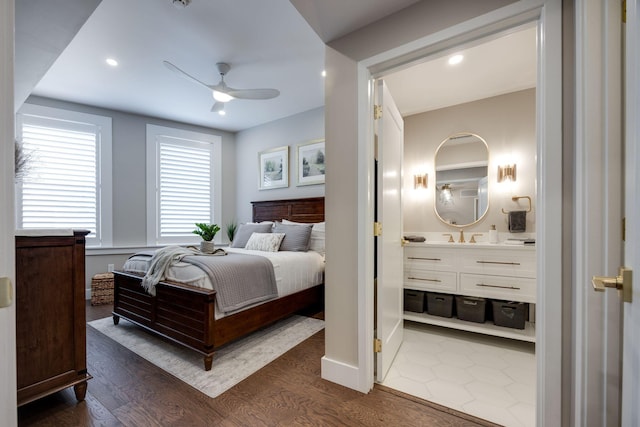 bedroom with recessed lighting, ensuite bath, dark wood finished floors, and ceiling fan