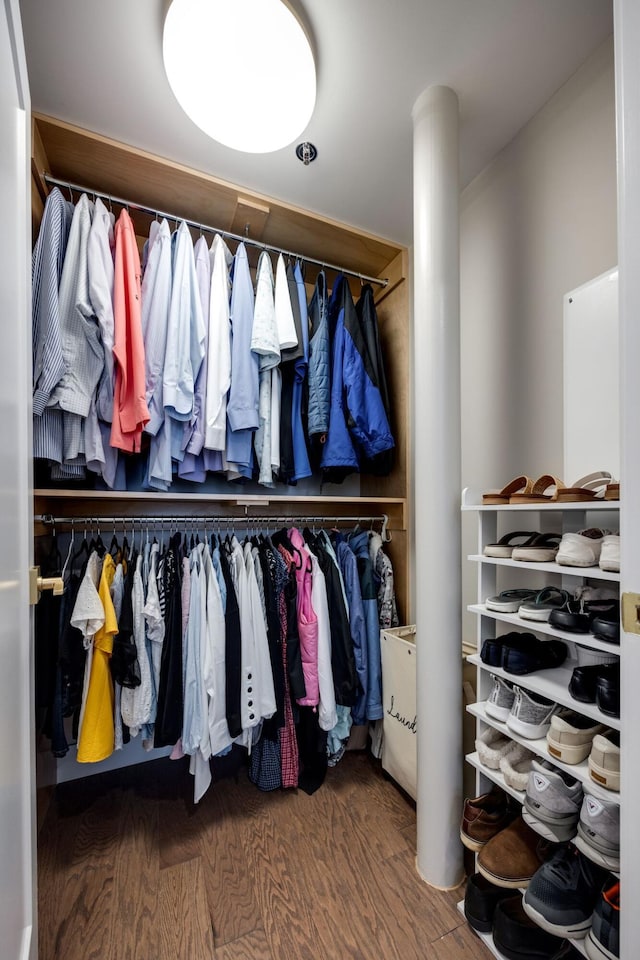 spacious closet with wood finished floors and ornate columns