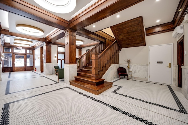 interior space featuring a wainscoted wall, a wall unit AC, recessed lighting, crown molding, and decorative columns