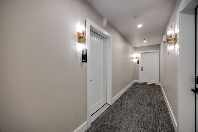 corridor featuring recessed lighting, dark carpet, and baseboards