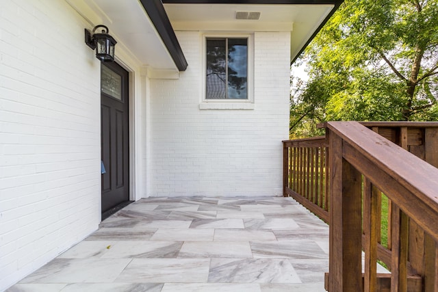 doorway to property with brick siding