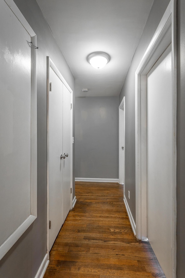 hall featuring wood finished floors and baseboards