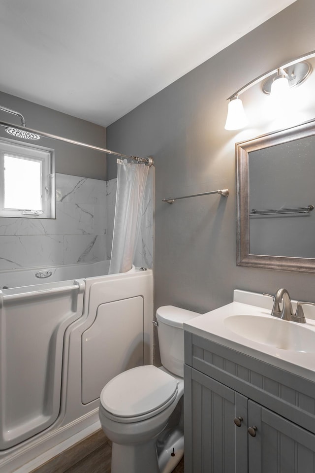 bathroom with toilet, shower / bath combo, wood finished floors, and vanity