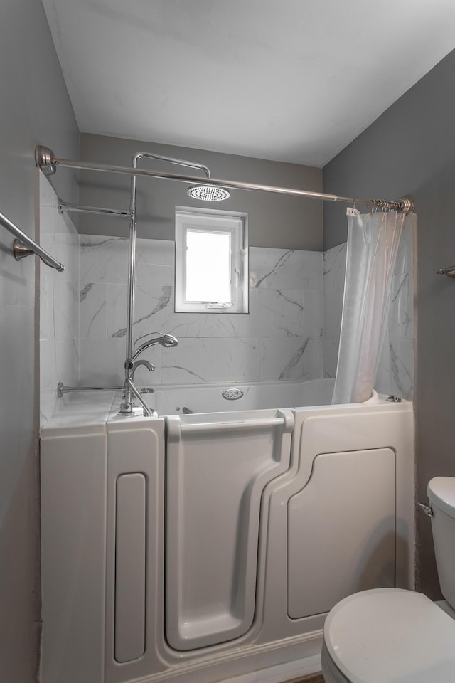 full bath featuring a shower with curtain, toilet, and a tub to relax in