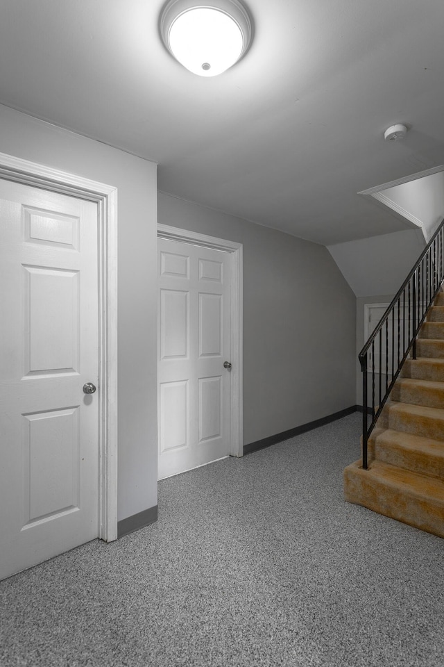 below grade area featuring stairway and baseboards