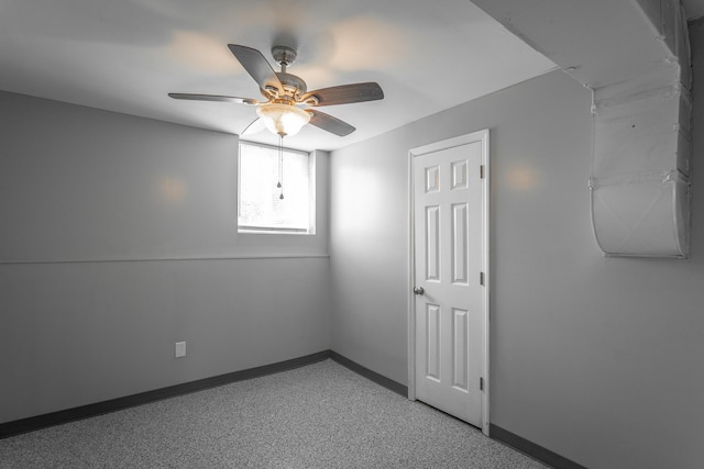 empty room featuring baseboards and ceiling fan