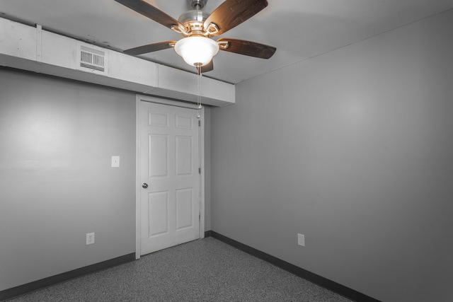 spare room with visible vents, a ceiling fan, and baseboards