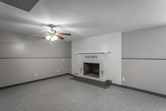 unfurnished living room with a fireplace, baseboards, and ceiling fan