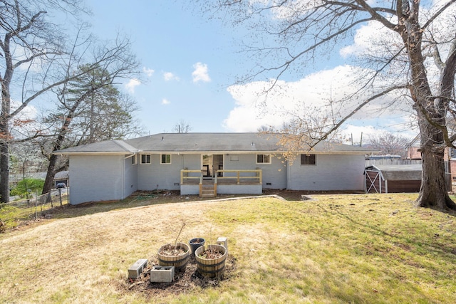 back of house featuring a lawn and fence