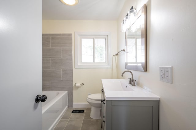 full bathroom featuring tile patterned floors, toilet, a tub to relax in, baseboards, and vanity