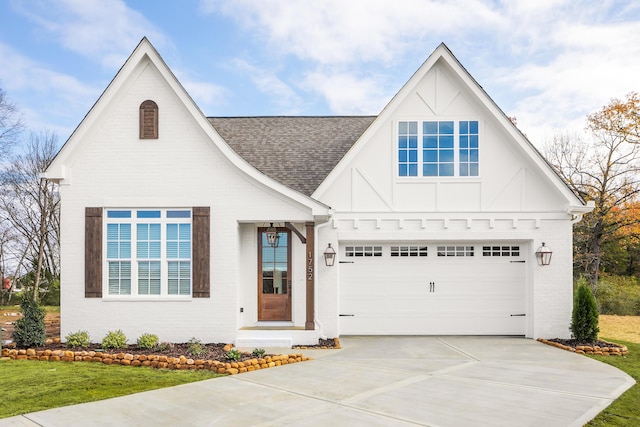 view of front of house with brick siding, roof with shingles, concrete driveway, and an attached garage