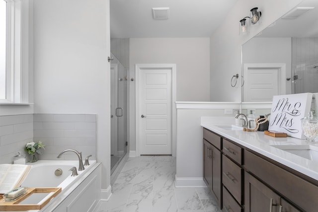 bathroom with visible vents, double vanity, a shower stall, a garden tub, and marble finish floor