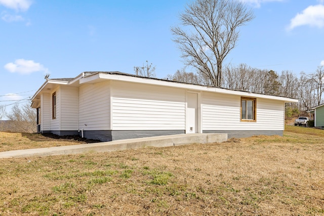 view of side of property with a yard