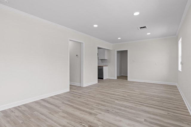 unfurnished room featuring visible vents, baseboards, light wood-style floors, and crown molding