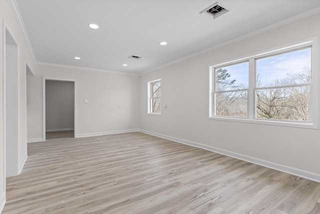 unfurnished room featuring visible vents, crown molding, and baseboards