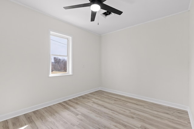 unfurnished room featuring light wood-type flooring, baseboards, ornamental molding, and a ceiling fan