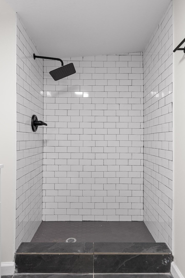 bathroom with tiled shower