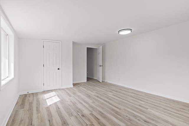 unfurnished bedroom with light wood-style floors and baseboards