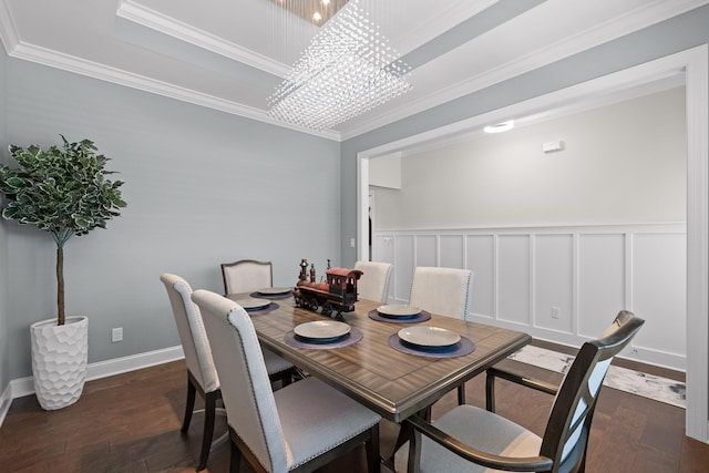 dining space featuring dark wood-type flooring, an inviting chandelier, and ornamental molding