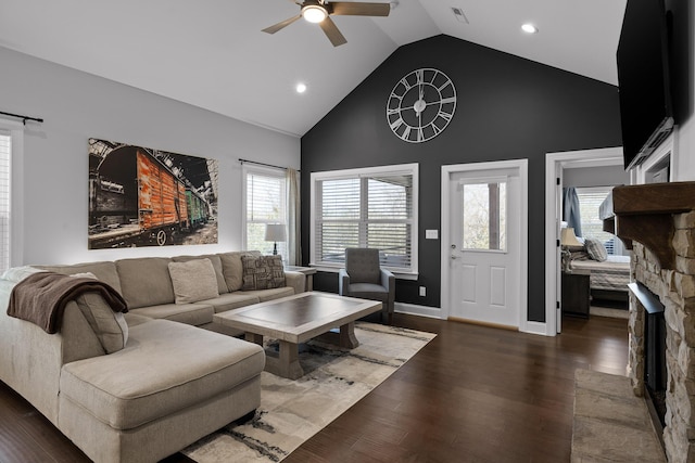 living area with a ceiling fan, baseboards, visible vents, high vaulted ceiling, and dark wood finished floors