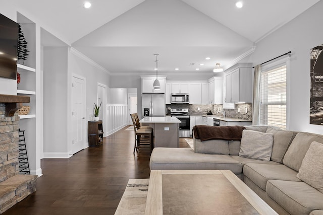 living area with built in features, dark wood-style floors, high vaulted ceiling, ornamental molding, and a stone fireplace