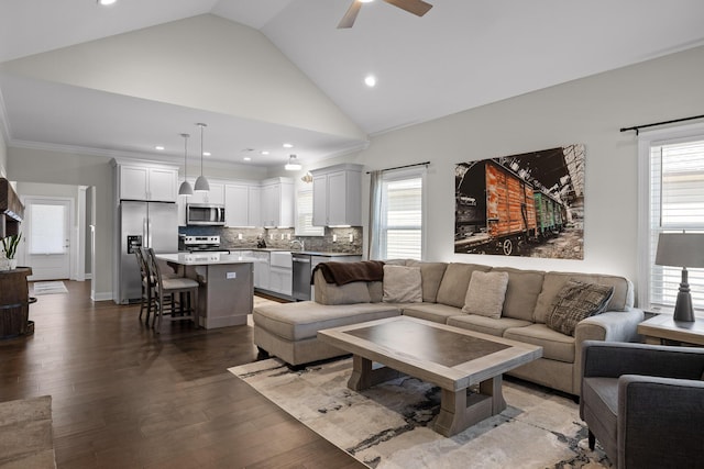 living area featuring light wood-type flooring, ornamental molding, recessed lighting, high vaulted ceiling, and a ceiling fan