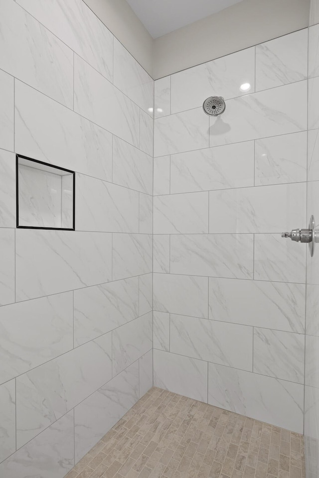 bathroom with tiled shower